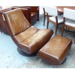 EASY CHAIR, in tanned leather on swivel support, 90cm W, plus a matching footstool.