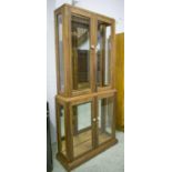 SHOP CABINET, American, walnut, with four glazed doors and internal spot lights,