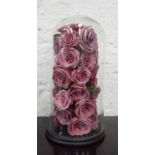 TABLE ORNAMENT, of faux roses in a glass dome, 53cm .