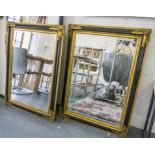 WALL MIRRORS, a pair, each with rectangular bevelled plates, in ebonised and gilded frames,