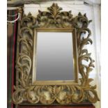 WALL MIRROR, Florentine style with a rectangular bevelled plate and leaf and scroll decoration,