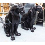 BLACK PANTHERS, a pair, seated, in resin, 71cm H.