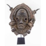 DAN FACE MASK, carved wood with leather and fabric surround,
