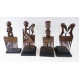 FOUR VARIOUS DECORATIVE COMBS, Cote d'Ivoire, carved wood, each approx. 27cm H, plus display stands.