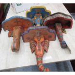 WALL BRACKETS, a set of four, elephants' heads, wooden carved and ornately decorated, 39cm H.