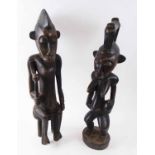 SENUFO FIGURES, a companion pair, male and female, carved wood, 57cm H and 62cm H.