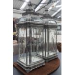 STORM LANTERNS, a pair, of square section in a metal frame, 96cm H.