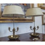 BOUILOTTE LAMPS, a pair, 1930's French brass, with cream painted tole shades, 73cm H x 36cm W.