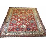 FINE KAZAK CARPET, 282cm x 246cm, geometric medallions on a ruby field,