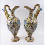 MAJOLICA EWERS, a pair, all-over decorated classical cavorting figures, each 54cm H.