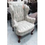 WING BACK ARMCHAIR, George II style, silk upholstered on carved cabriole front supports.