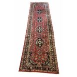 FINE KASHAN RUNNER, 283cm x 79cm, row of pendant medallions on a ruby palmette and vine field,