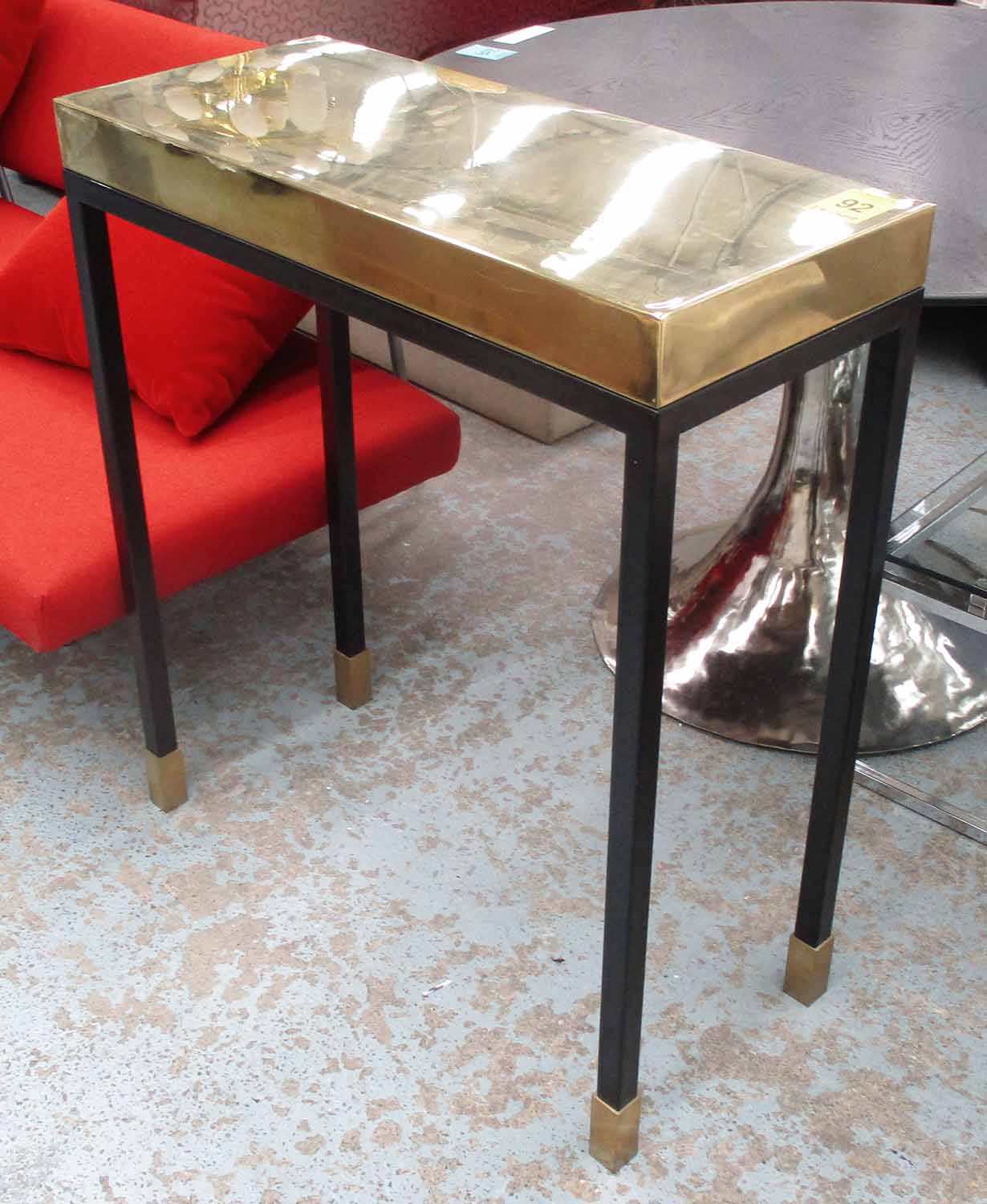 CONSOLE TABLE, brass top on black painted base, 79cm W X 90cm H.