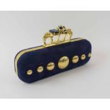 ALEXANDER MCQUEEN CLUTCH, navy nappa leather with iconic knuckle skulls and clasp with blue ring,