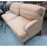 HOWARD STYLE SOFA, two seater in neutral fabric, on turned castor supports, 186cm L.