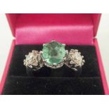 18K WHITE GOLD THREE STONE EMERALD AND DIAMONDS RING, central emerald 3cts, two diamonds 1.