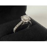 A FINE 18K WHITE GOLD AND DIAMOND SET RING, the central stone of 2.