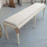 LONG STOOL, Victorian style, on reeded legs in cream painted finish, with stuff-over seat,