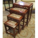 CHINESE QUARTETTO TABLES, a set of four graduated, each with a marble top,