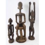 THREE VARIOUS DOGON FIGURES, Mali, carved wood, tallest 61cm H.