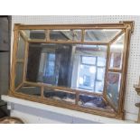 WALL MIRROR, Edwardian the beaded shaped gilt frame enclosing bevelled divided plates,