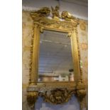 WALL MIRROR, gilt effect with a putto surmount, leaf,