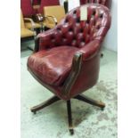 DESK CHAIR, of tub form, distressed red leather button back, swivel action, 67cm x 102cm H.