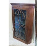 HANGING CORNER CABINET, George III mahogany and inlaid with glazed door enclosing painted shelves,