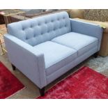 SOFA, two seater, upholsteed in light blue fabric, back with buttons on tapered dark wooden legs,