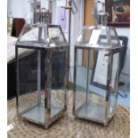 STORM LANTERNS, a pair, square form in chromed metal frames, 68cm H.