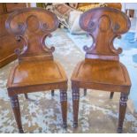 HALL CHAIRS, a pair, Regency mahogany each with scroll reeded backs and chanelled panel seat.