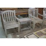 GARDEN ARMCHAIRS, a pair. weathered teak, together with a teak low table, 50cm H x 46cm x 36cm D.