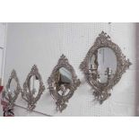 GIRANDOLES, a set of four, 1920's nickeled bronze, with oval mirrored backs and three lights,