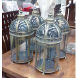 STORM LANTERNS, a set of four, in a gilded metal finish, 52cm H.