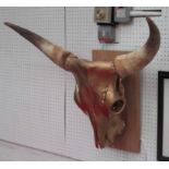 'BULLY!' bespoke wall sconce by Bee Rich, mounted bull skull with lit interior, 75cm W.