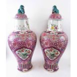 ORIENTAL LIDDED VASES, a pair, famille rose ceramic, decorated with flowering scenes in cartouches,