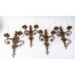 SET OF FOUR FIGURAL WALL LIGHTS, gilt metal each with twin lighting arms, 40cm H overall.