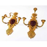 GILT BRONZE WALL APPLIQUES, a pair, each with central female face mask and three lighting arms,