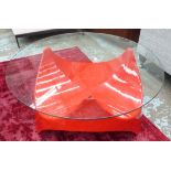 VINTAGE LOW TABLE, 1960's, the circular glass top on shaped red base, 90cm W x 44cm H.