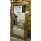 CONTEMPORARY WALL MIRROR, rectangular bevelled mirror in an antiqued broad copper frame,