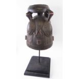 SENUFO HELMET MASK, carved wood with entwined snake detail, 36cm H, plus a display stand.
