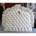 HEADBOARD, with white painted carved foliate and floral detail surrounding a buttoned,