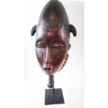 BAULE FACE MASK, Cote d'Ivoire, carved wood, approx 50cm H x 26cm W, plus display stand.