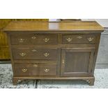 DRESSER BASE, George III and later oak with four drawers and single door, 93cm H x 132cm x 48cm.