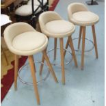 BAR STOOLS, three, contemporary design in beige leather on beech legs with tubular chrome stretcher.