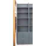 TALL OPEN WATERFALL BOOKCASE, bespoke, with base cabinet in a dark grey/blue painted finish,