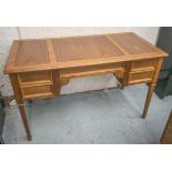 DESK, walnut with a rectangular top and five drawers below on square tapered supports,