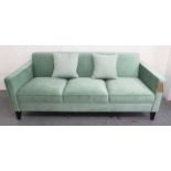 SOFA, three seater, in green velvet on square supports, with a pair of scatter cushions, 192cm L.