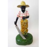 BLACKAMOOR FIGURE, polychrome with bananas and machete, 69cm H.