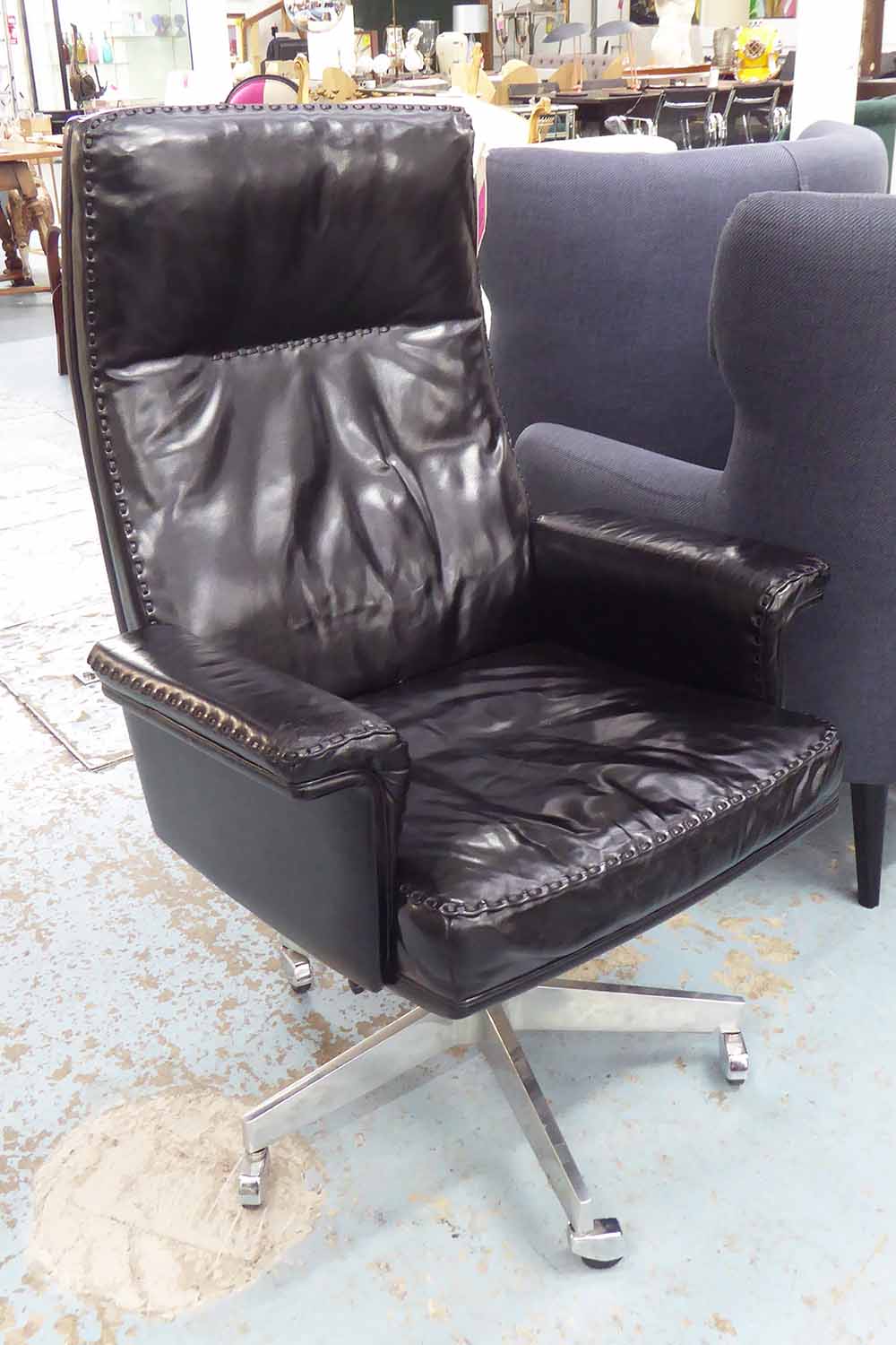 DE SEDE DS 35 EXECUTIVE DESK CHAIR, in black leather on chromed castors, 76cm W.